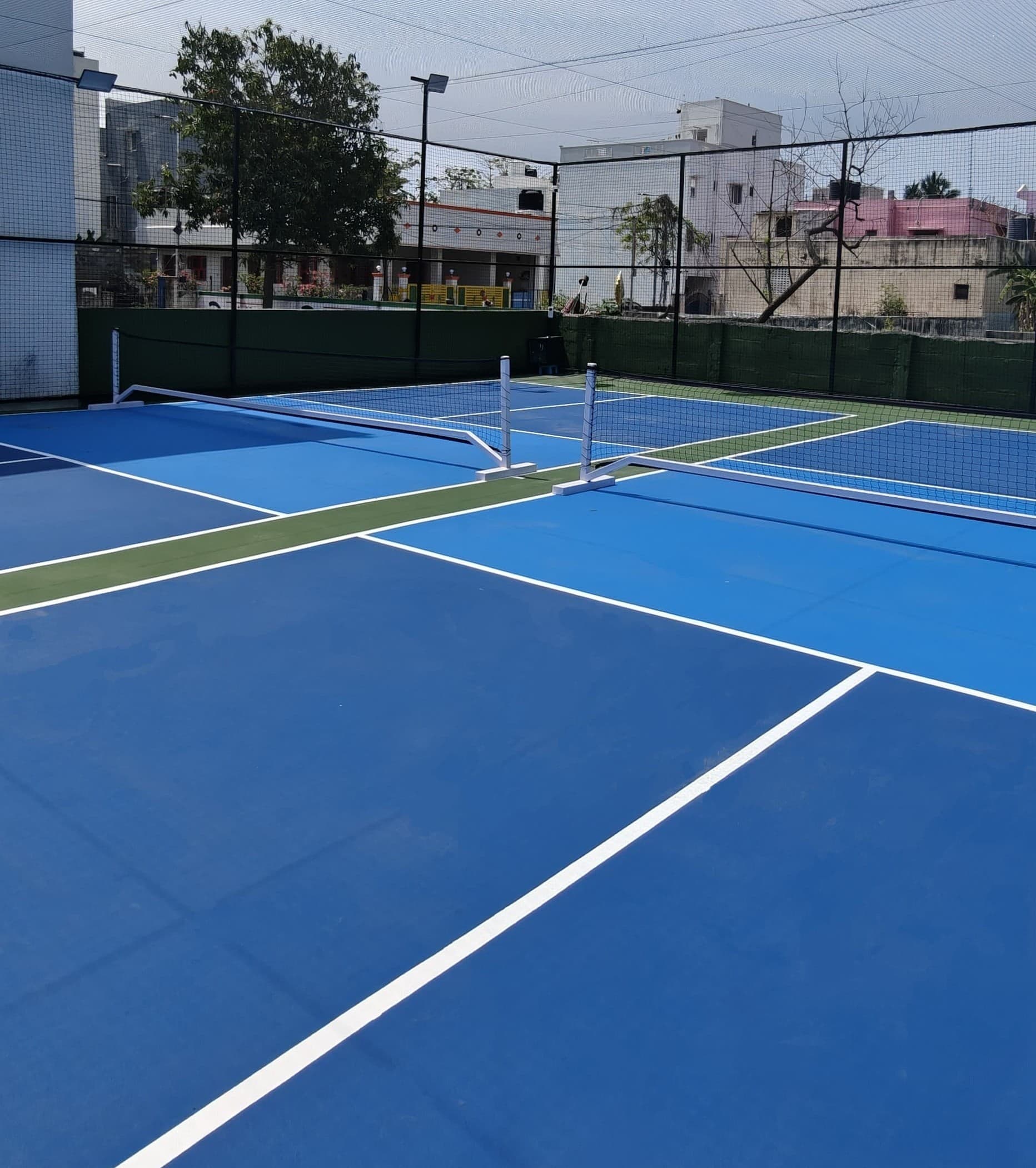 Blue courts, green vibes, and open skies. Step into serenity and sport at Paddle Playhouse.